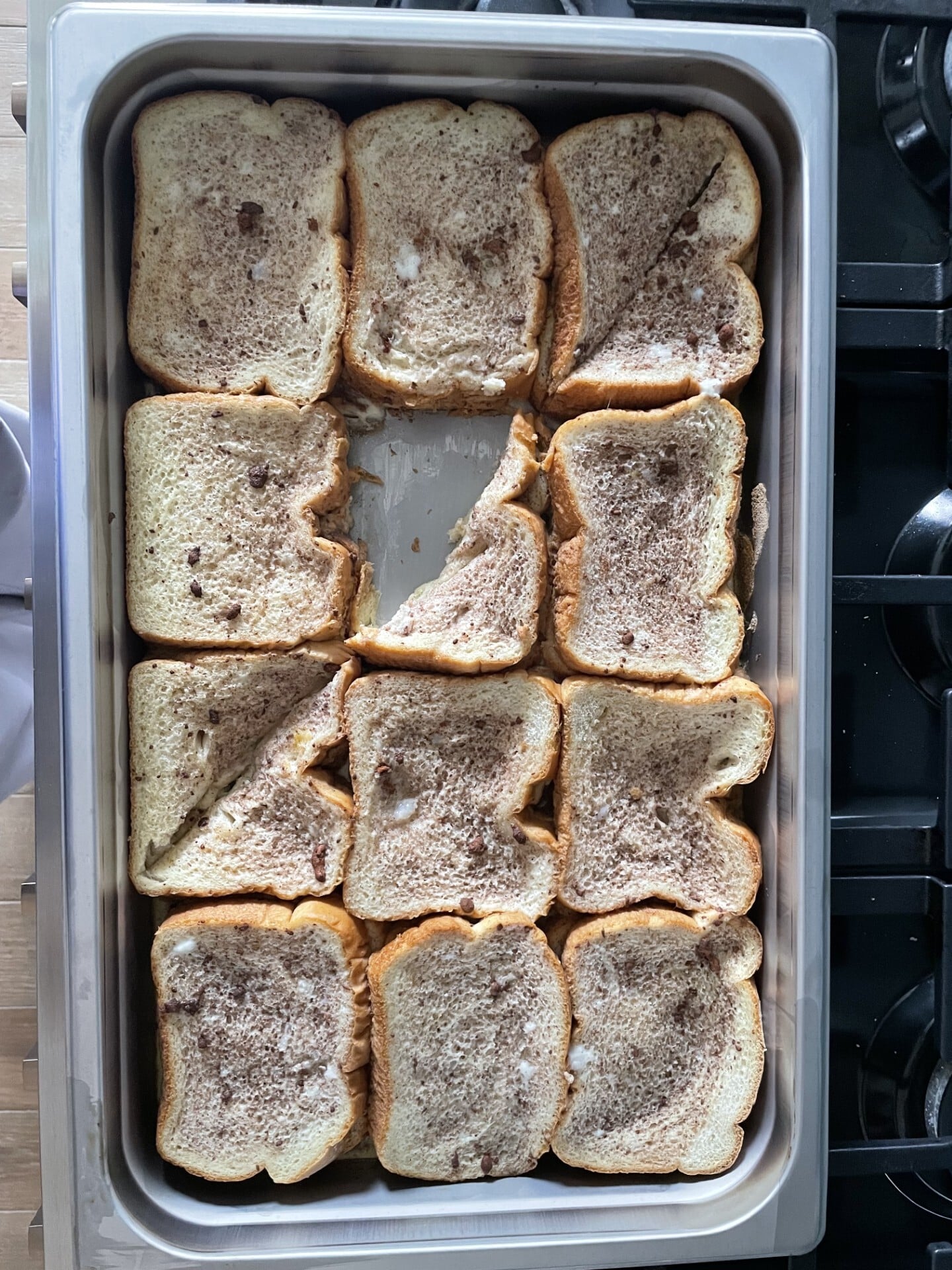 A full hotel pan of French toast bake, with some slices cut on the diagonal